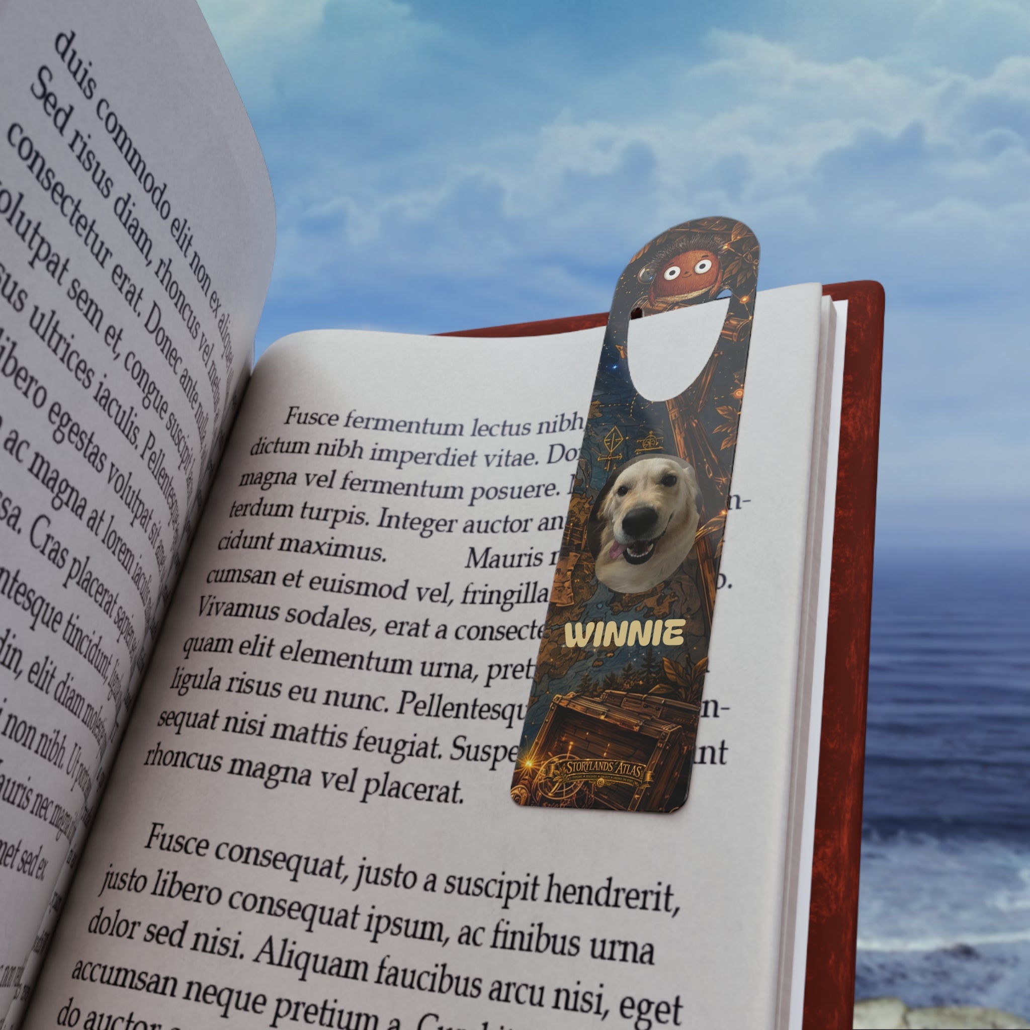Book with a bookmark featuring a dog and the name 'Winnie' against a scenic background.